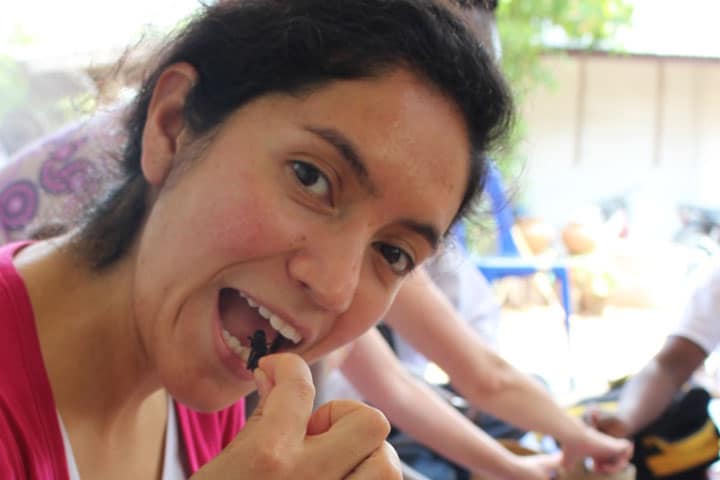 GREEiNSECT/AgTrain PhD student Gabriella Vergara taste cricket roasted in lemongrass-roasted during the GREEiNSECT study tour to Thailand where Kenyan and international partners learnt about cricket farming. Photo: GREEiNSECT